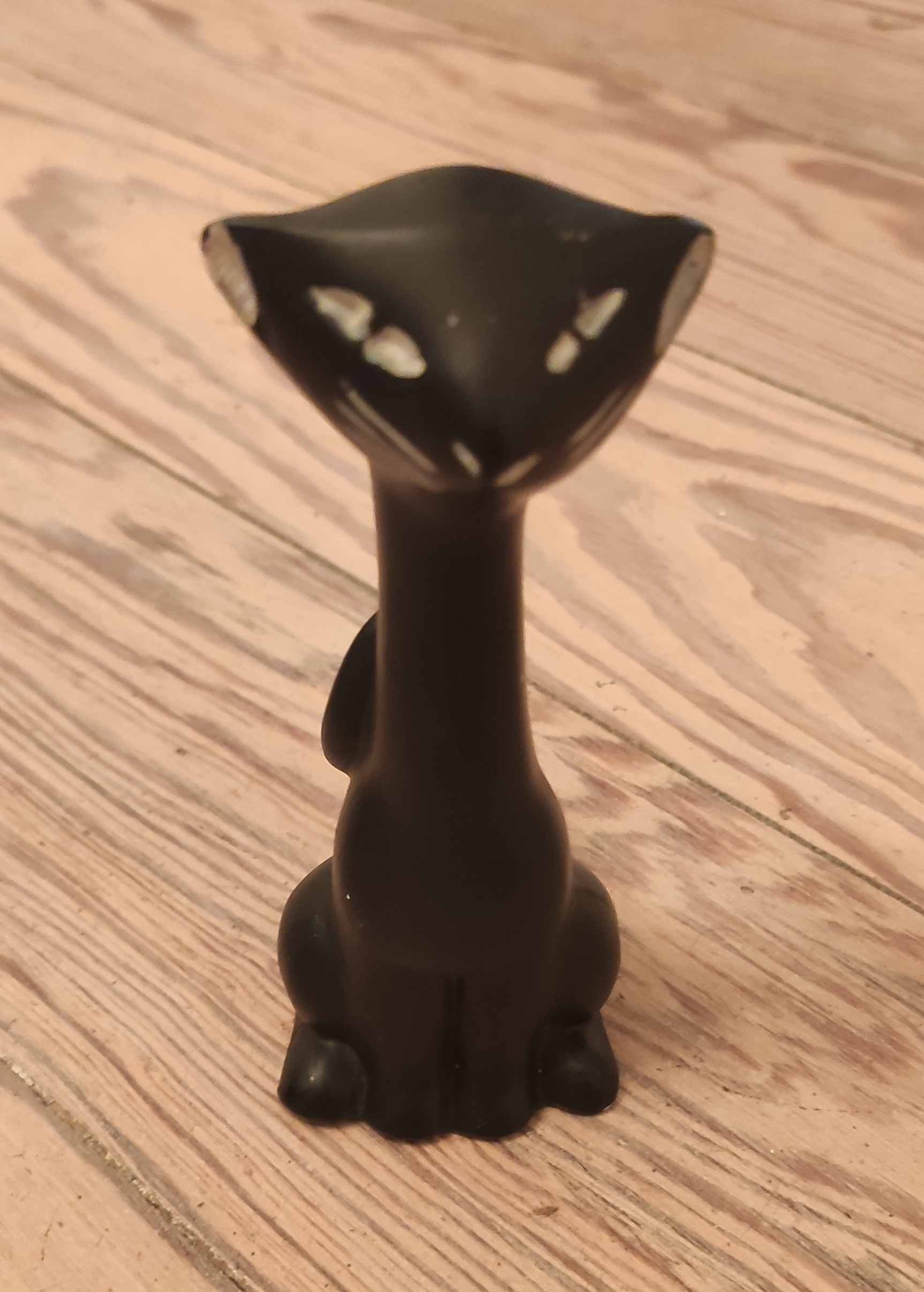 Front shot of a tall black cat figurine made of chalkware