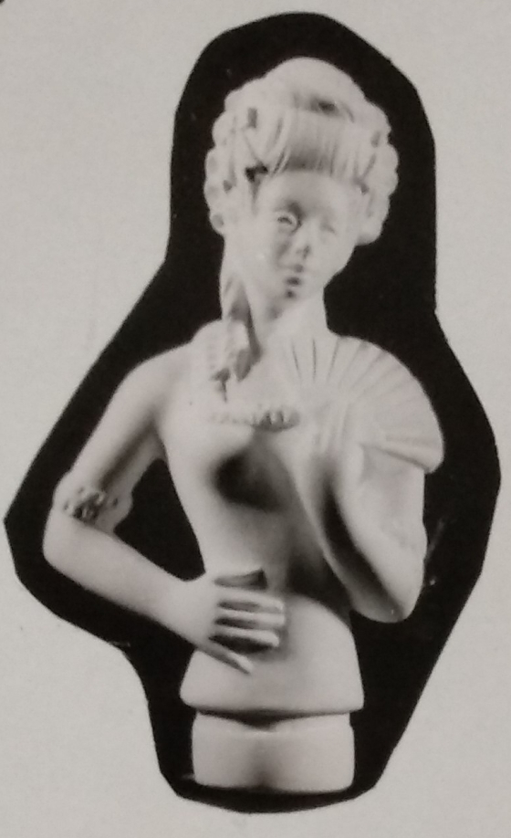 Lady figurine made of chalkware with lady holding a fan in left hand