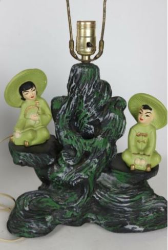 a chalkware lamp with two geisha looking girls sitting on it